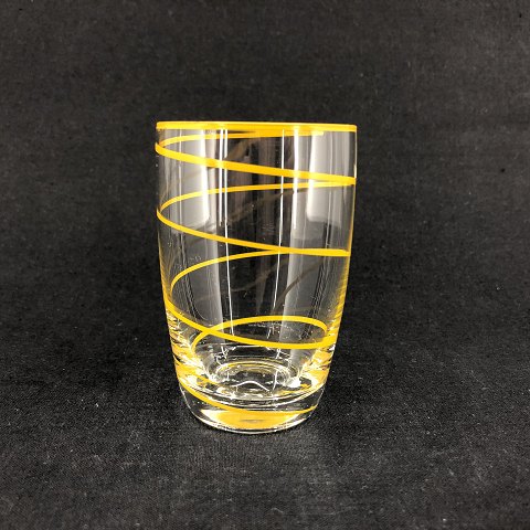 Drinking glass with yellow stripe by Jacob E. Bang
