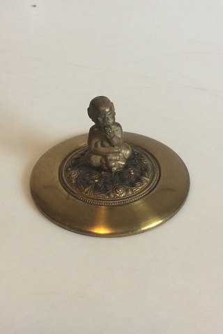 Lid of brass with Bacchus figurine