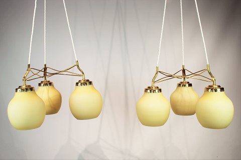 A pair of ceiling pendants of brass and light yellow shades by Vilhelm Lauritzen 
from the 1960s.
5000m2 showroom.