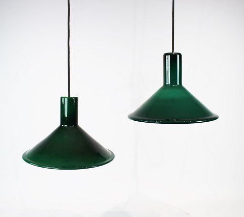 A pair of dark green P&T glass pendants by Michael Bang for Holmegaard.
50002 showroom.
