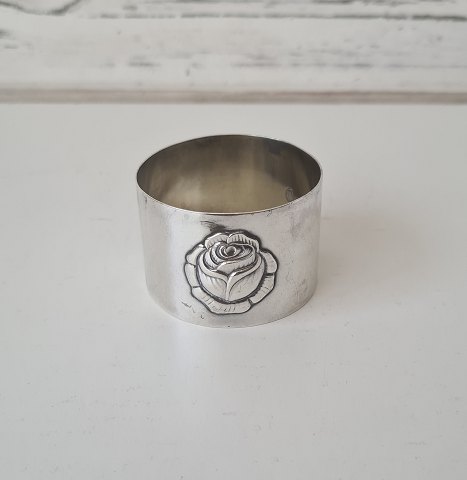 Wide silver napkin ring decorated with roses