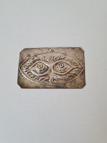 Votive in silver with motif of a pair of eyes