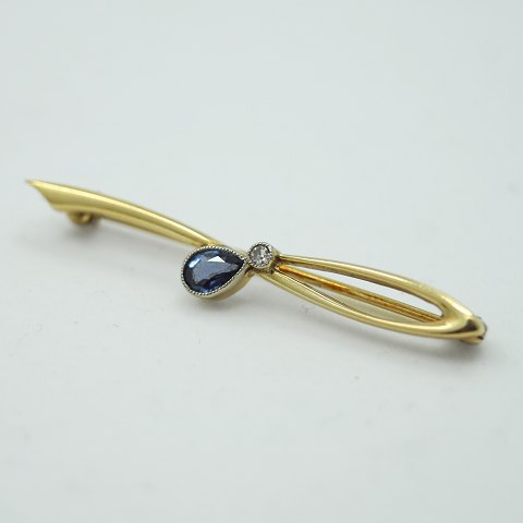 A. Dragsted; A Brooch of 14k gold, set with diamond and sapphire