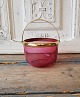 1800s sugar bowl in raspberry colored glass with brass handle