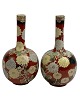 Pair of Asian vases, presumably Japanese. 20th century. Iron glaze with flowers.
