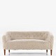 Ludvig Pontoppidan
Overstuffed sofa in new lambskin (colour: Moonlight) with legs in stained 
beech.
1 pc. in stock
Renovated
