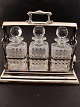 Tantalus in silver-plated holder with 3 cut crystal decanters