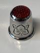 Finger ring of sterling silver with red glass.