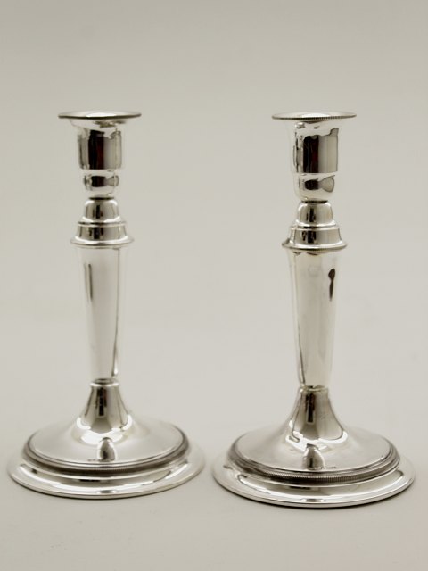 A pair of 830 silver candlesticks sold