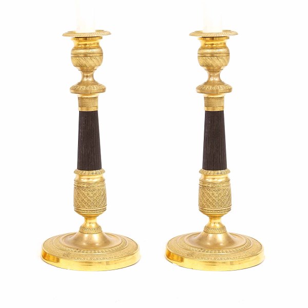 A pair of fire gilt bronze candlestick. France circa 1820. H: 27cm